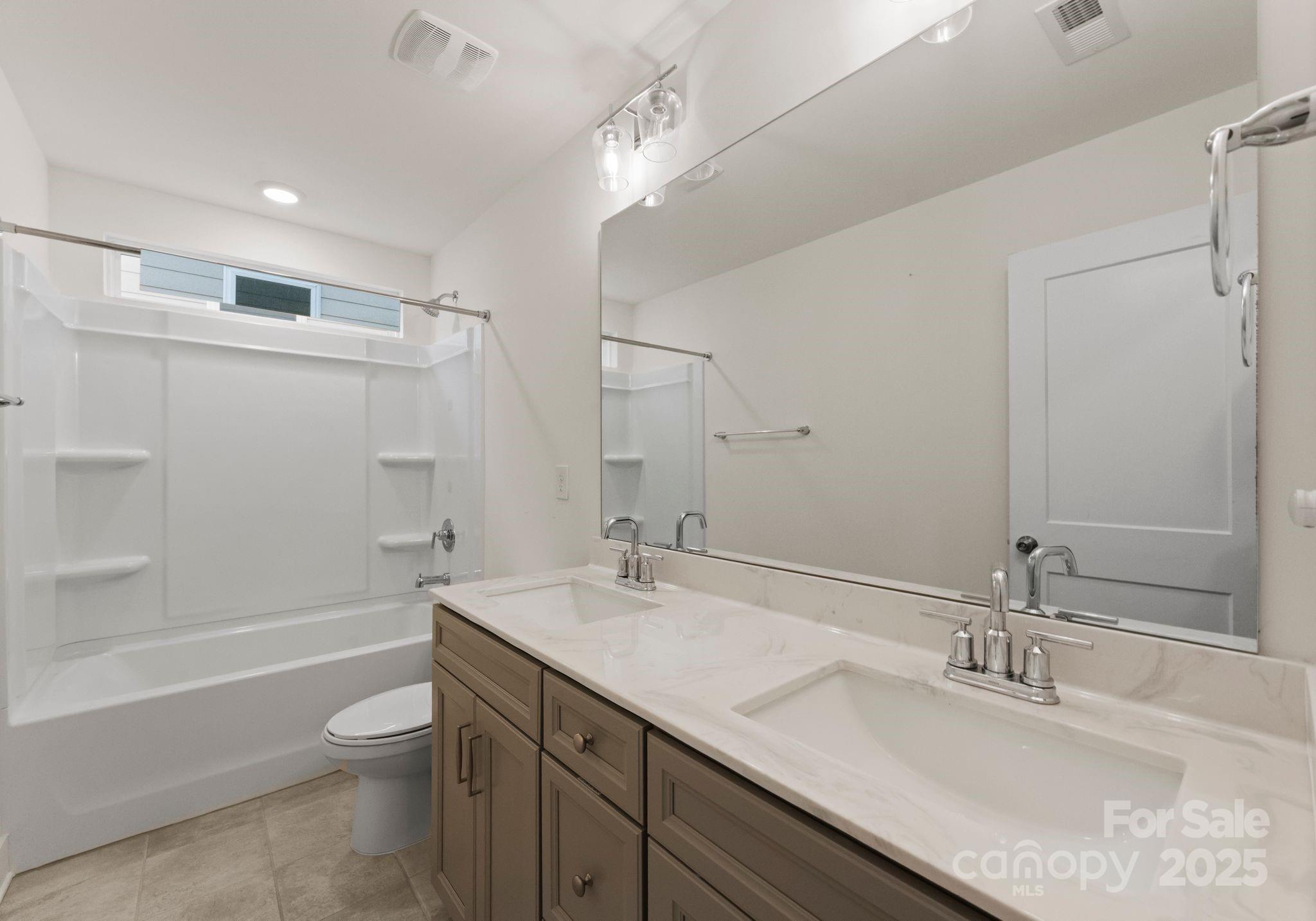 619-r L R L Stowe Road Belmont, NC 28012 - Photo 24 of 33 a bathroom with a granite countertop sink mirror toilet and bathtub