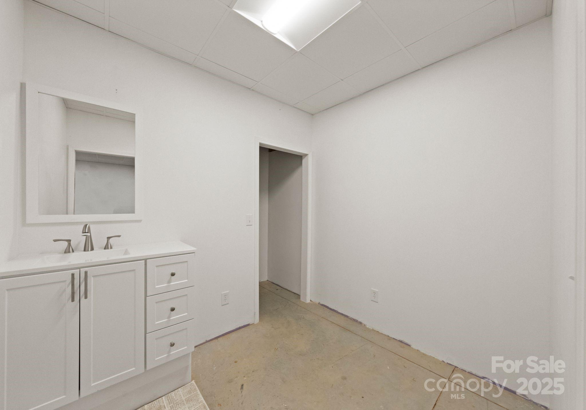 619-r L R L Stowe Road Belmont, NC 28012 - Photo 28 of 33 a bathroom with a double vanity sink and mirror