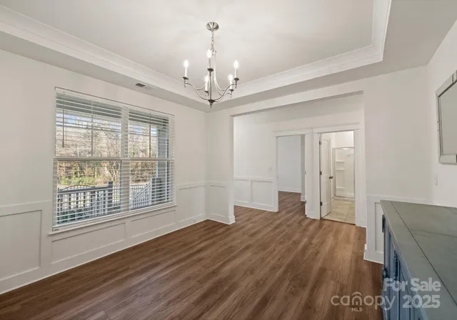 a furnished livingroom with windows and wooden floor