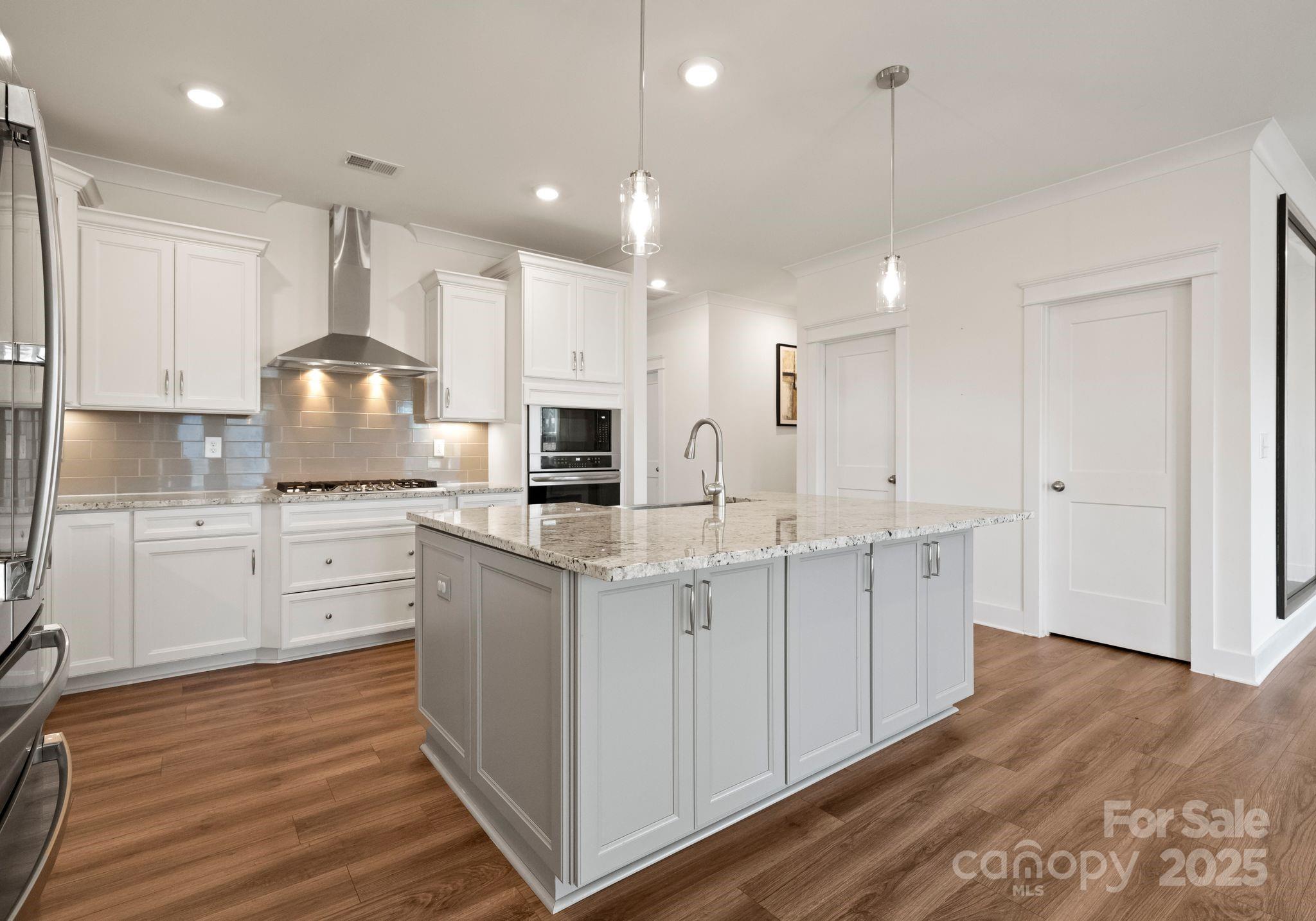 619-r L R L Stowe Road Belmont, NC 28012 - Photo 9 of 33 a kitchen with white cabinets and stainless steel appliances