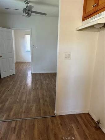 a view of a room with wooden floor and a window