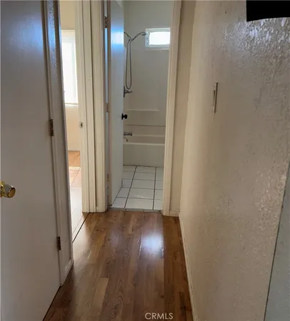 a view of a hallway with wooden floor