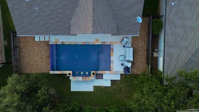an aerial view of residential houses with outdoor space and street view