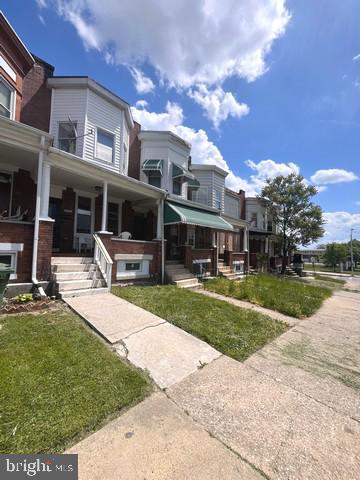 a front view of a house with a yard table and chairs