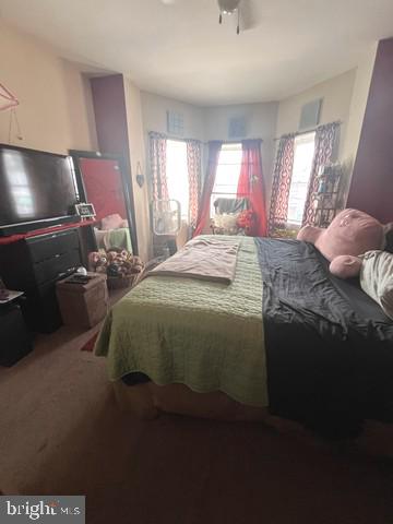 1711 North Pulaski Street Baltimore, MD 21217 - Photo 14 of 14 a bed sitting in a spacious bedroom next to a window