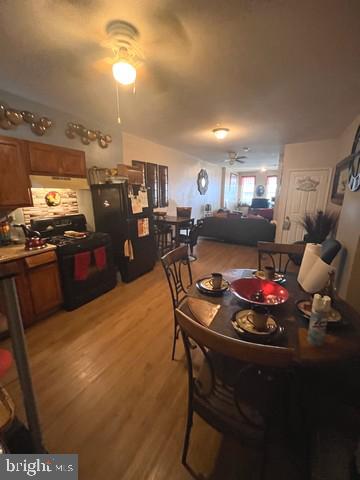 1711 North Pulaski Street Baltimore, MD 21217 - Photo 7 of 14 a kitchen with stainless steel appliances dining table and chairs