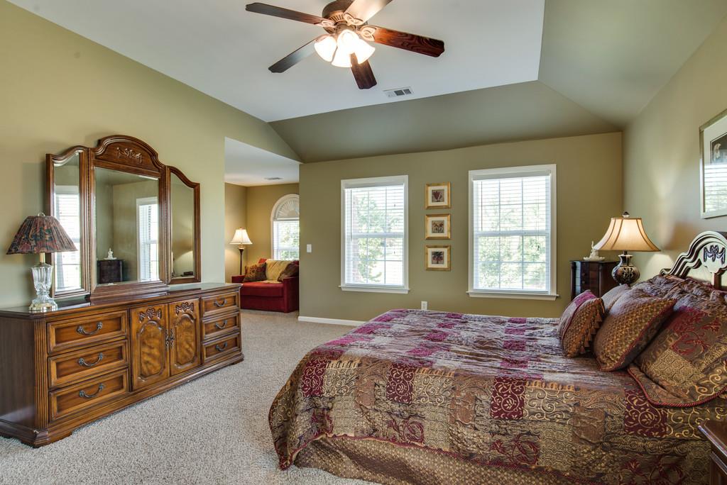 508 Rafe Court Franklin, TN 37064 - Photo 14 of 30 a spacious bedroom with a large bed and a chandelier
