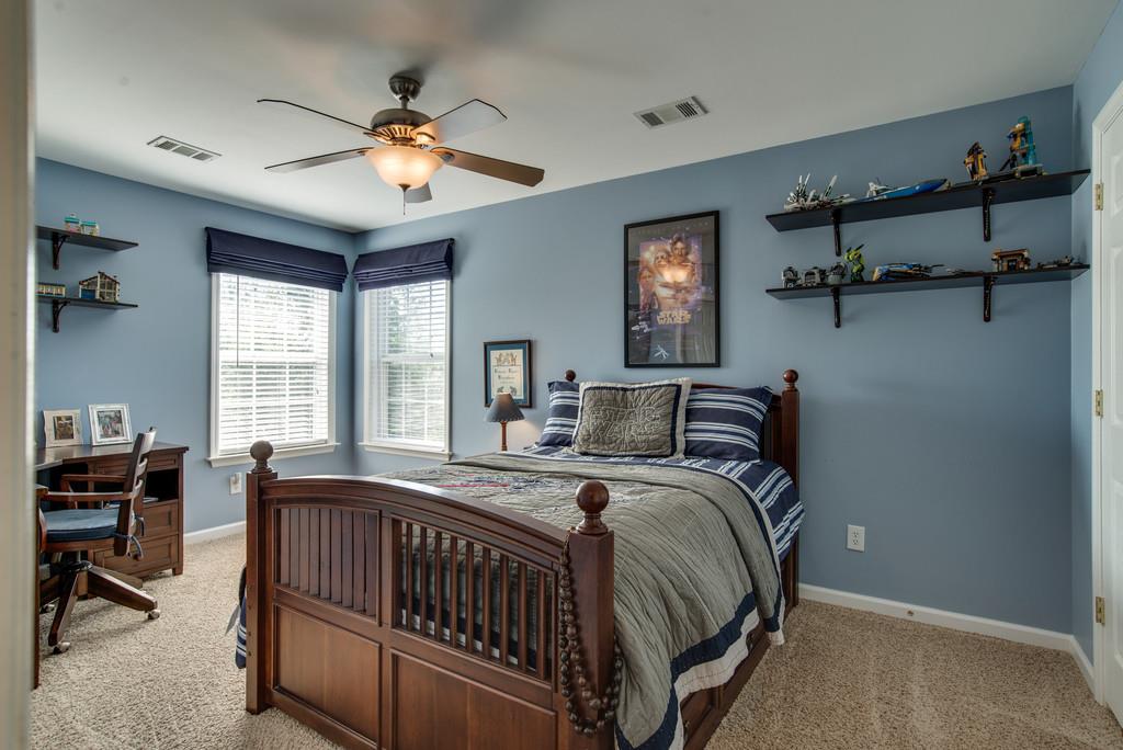 508 Rafe Court Franklin, TN 37064 - Photo 19 of 30 a bedroom with bed and a chandelier