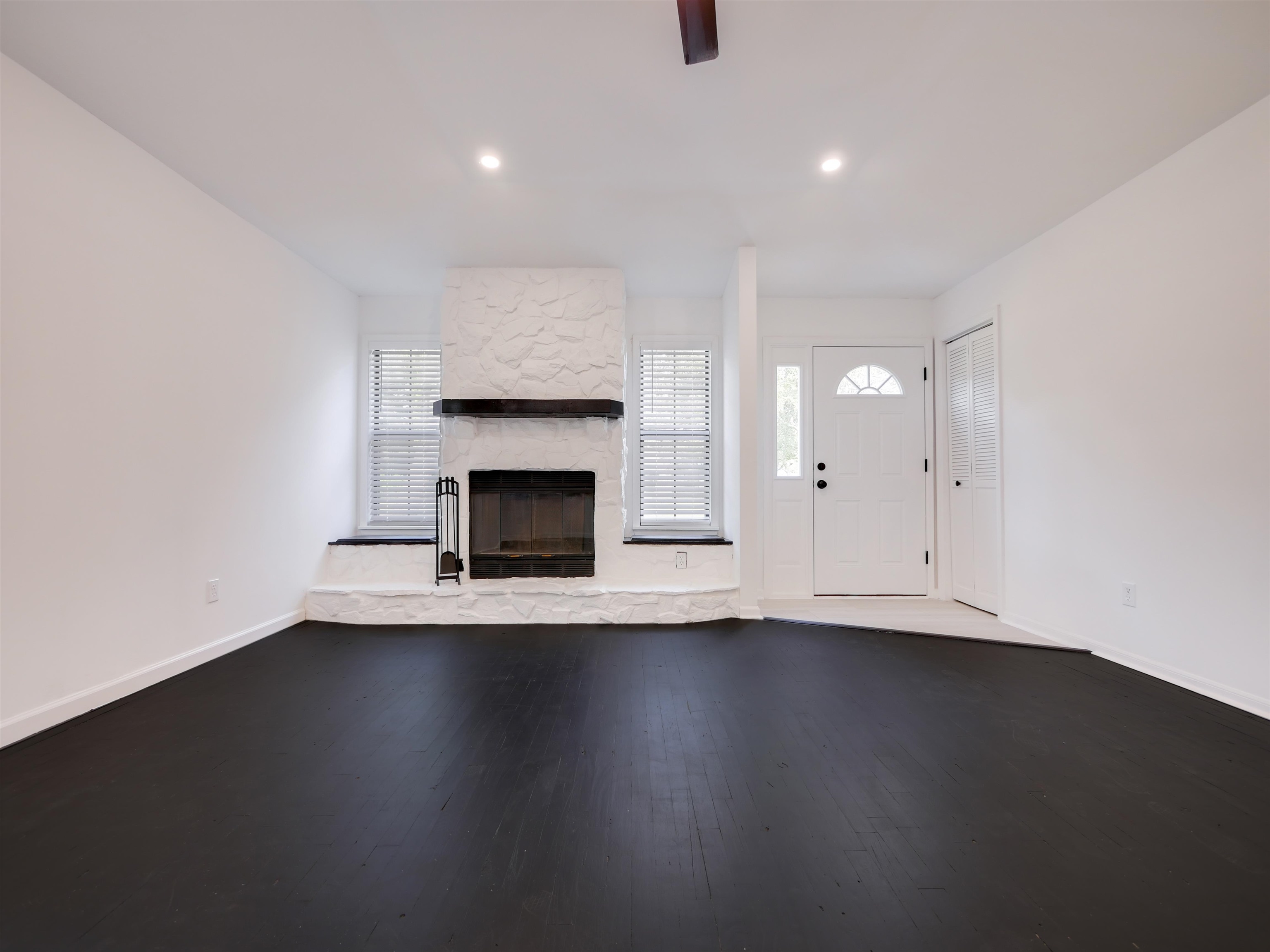136 Bonita Road St. Augustine, FL 32086 - Photo 2 of 26 an empty room with a fireplace and wooden floor