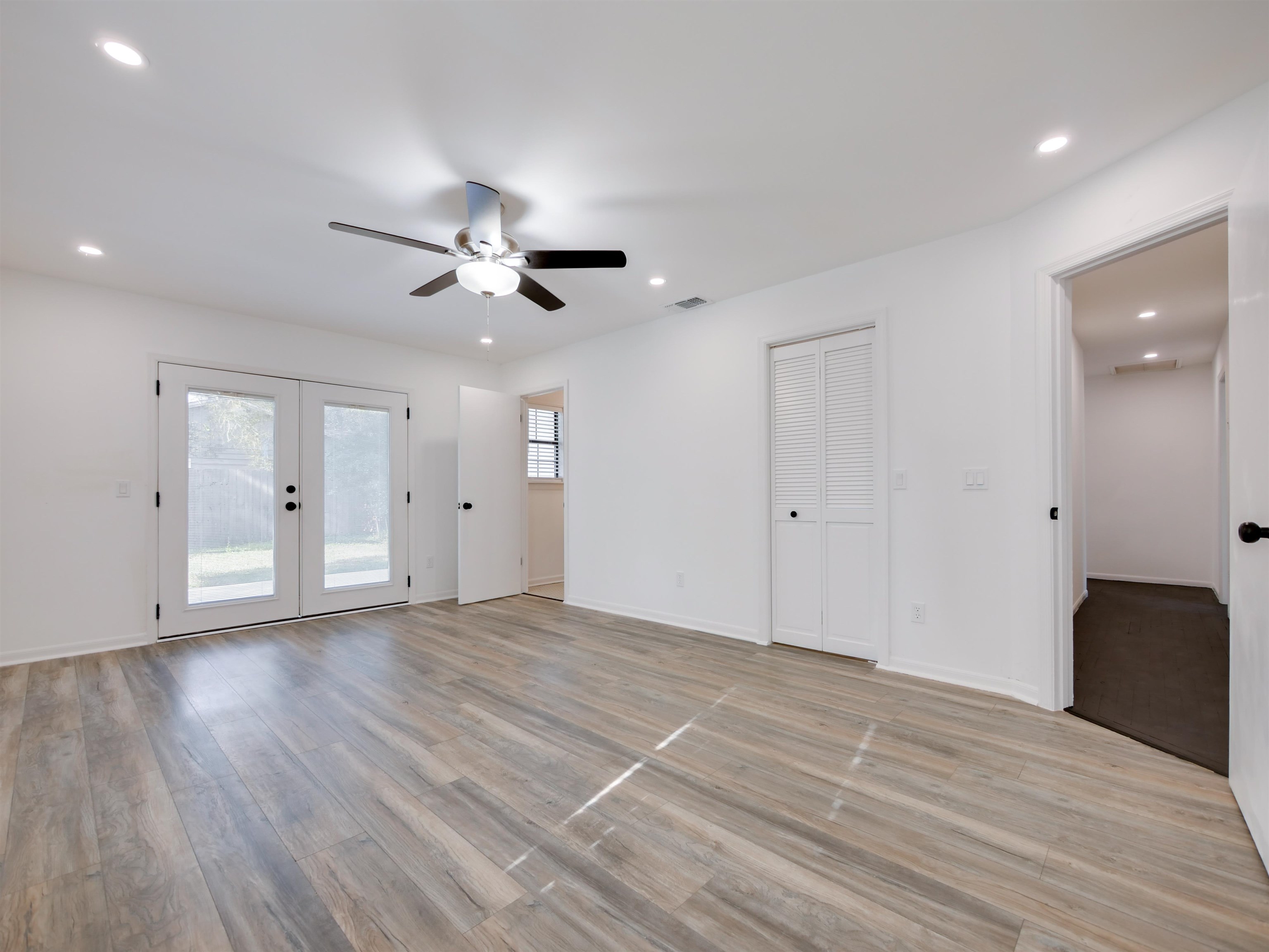 136 Bonita Road St. Augustine, FL 32086 - Photo 15 of 26 a view of an empty room with wooden floor and a ceiling fan