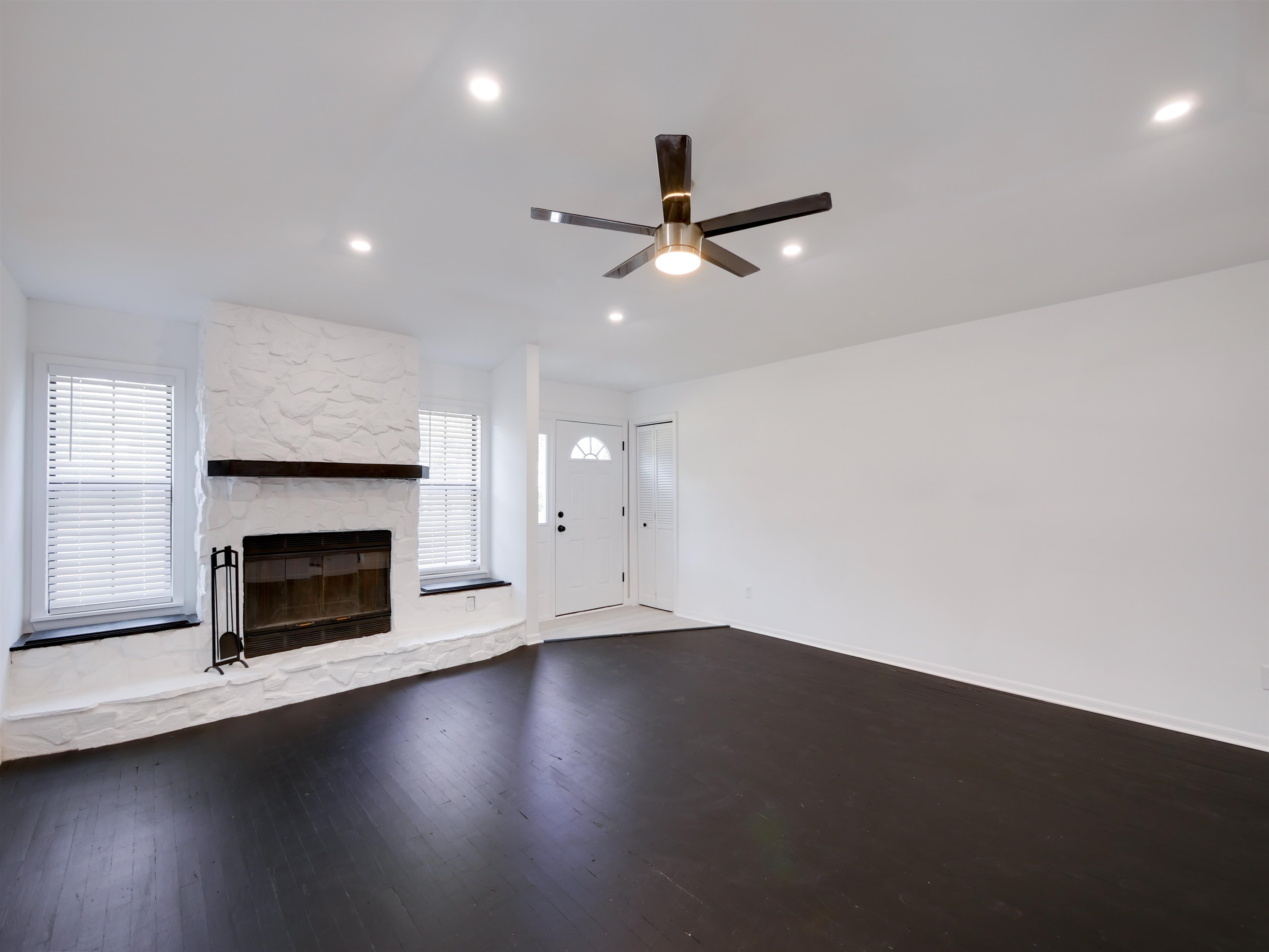 136 Bonita Road St. Augustine, FL 32086 - Photo 3 of 26 an empty room with wooden floor fireplace and windows
