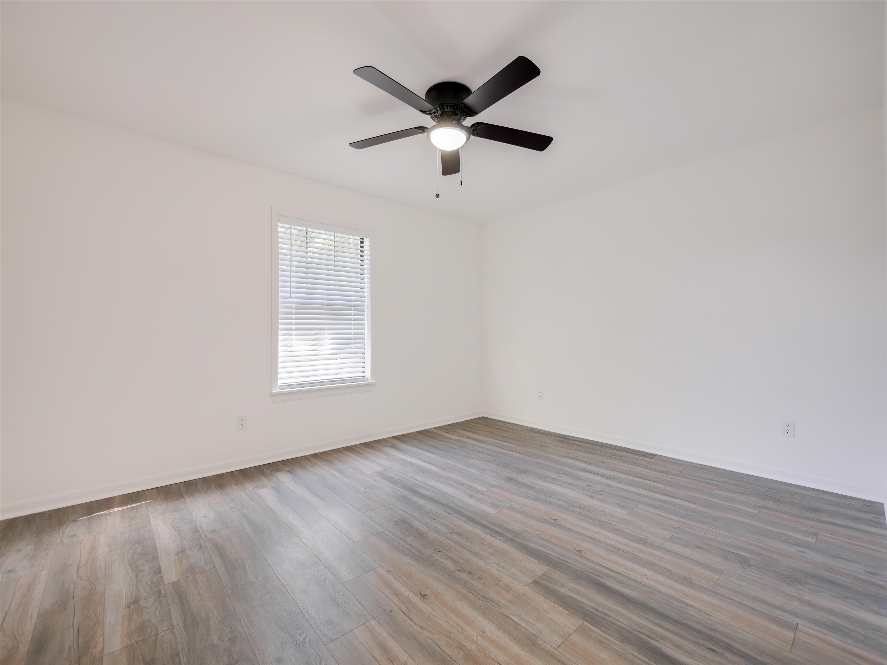 136 Bonita Road St. Augustine, FL 32086 - Photo 21 of 26 an empty room with wooden floor and ceiling fan