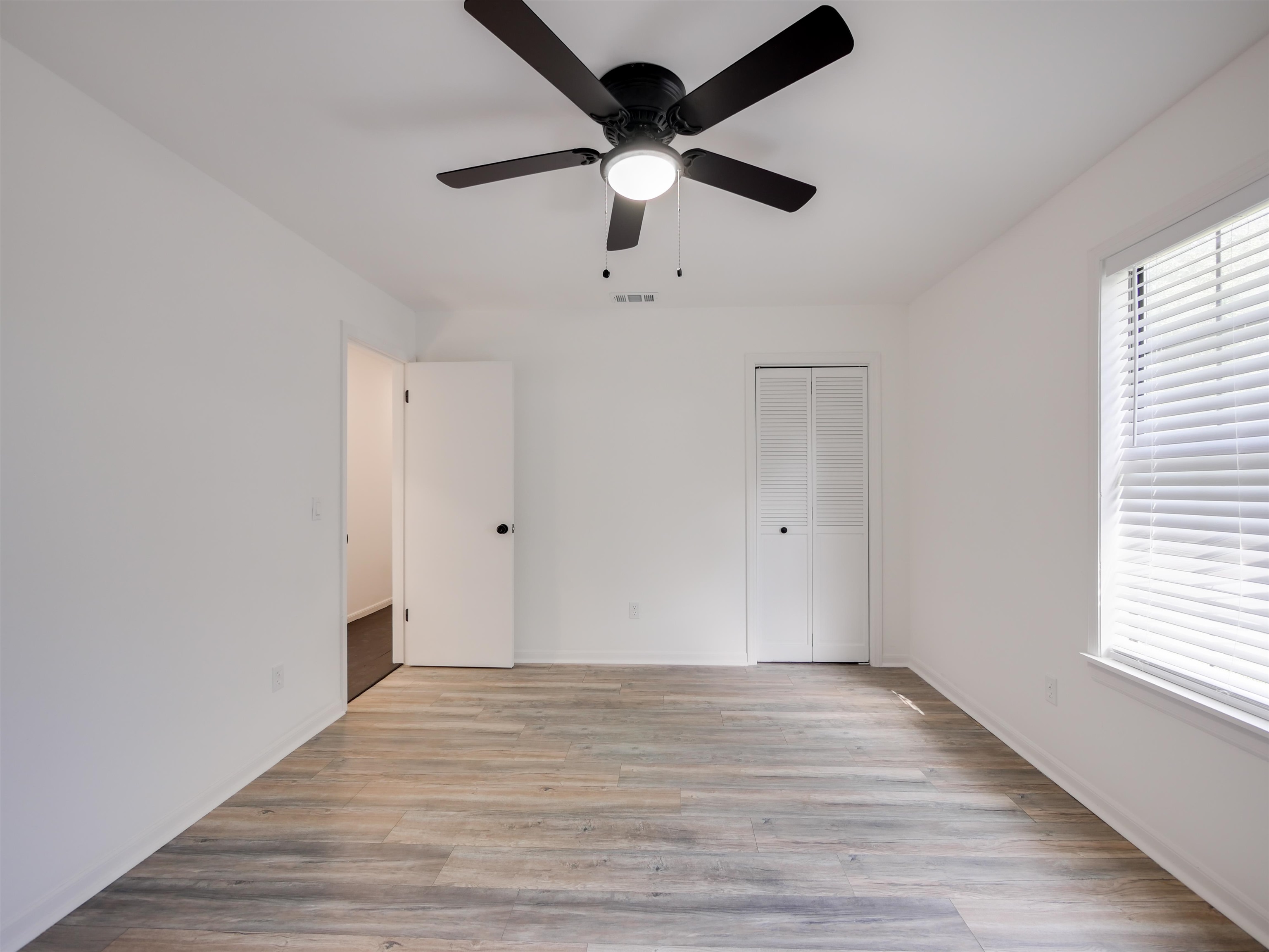 136 Bonita Road St. Augustine, FL 32086 - Photo 22 of 26 a view of an empty room with wooden floor and a window