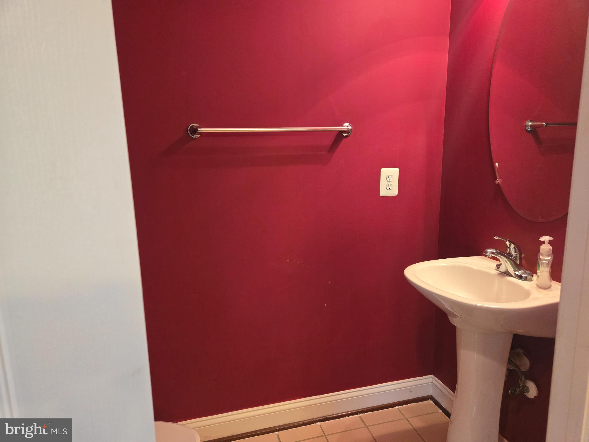 6444 5th Street Alexandria, VA 22312 - Photo 12 of 34 Vibrant red walls enhance this cozy bathroom.