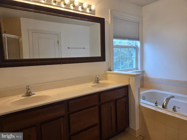 a bathroom with a double vanity sink and mirror
