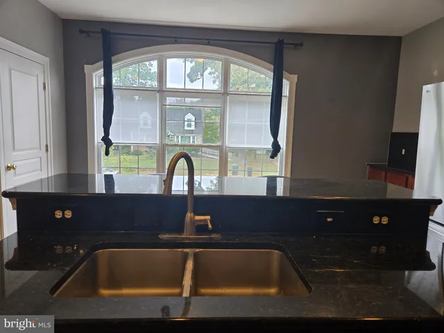 a bathroom with a sink a bathtub and a window