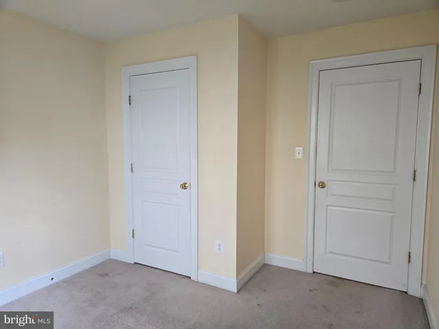 a view of an empty room with a closet