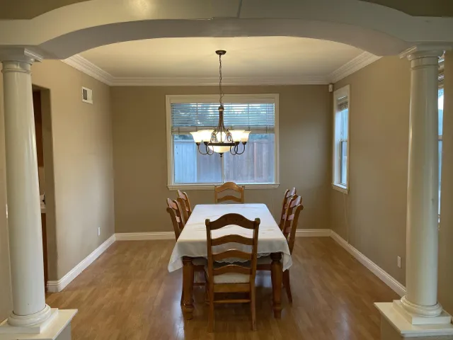 a view of a dining room with furniture wooden floor and a chandelier
