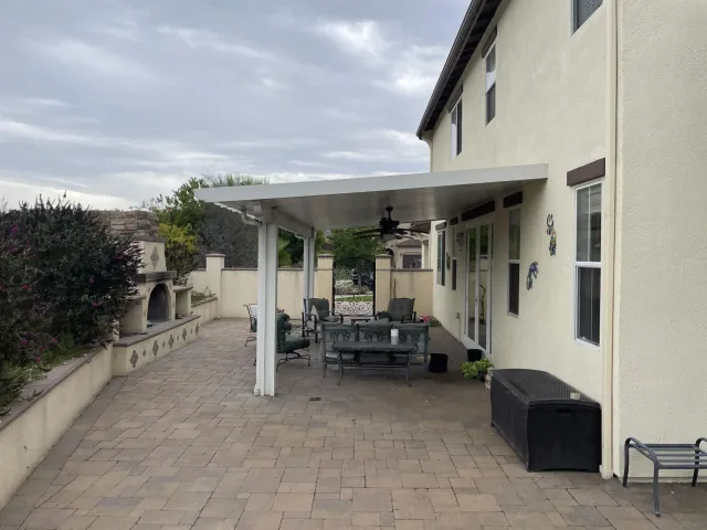 a view of an outdoor dining space with furniture and wooden floor