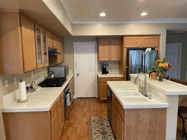 a kitchen with stainless steel appliances a sink stove and cabinets
