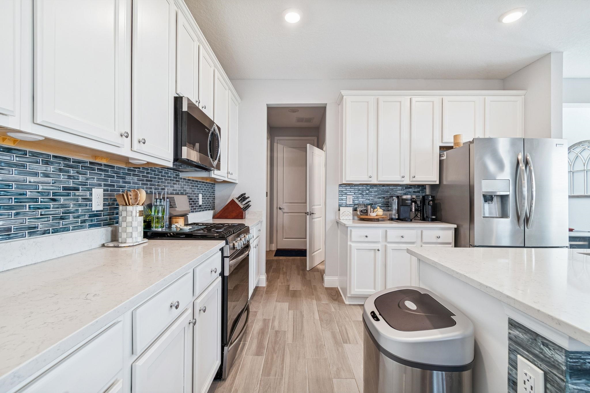 262 Killarney Avenue St. Johns, FL 32259 - Photo 12 of 100 Kitchen with stainless steel appliances, light stone counters, white cabinetry, and recessed lighting