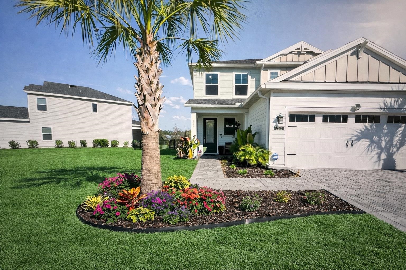 262 Killarney Avenue St. Johns, FL 32259 - Photo 2 of 100 View of front of home featuring a front lawn, board and batten siding, decorative driveway, and an attached garage