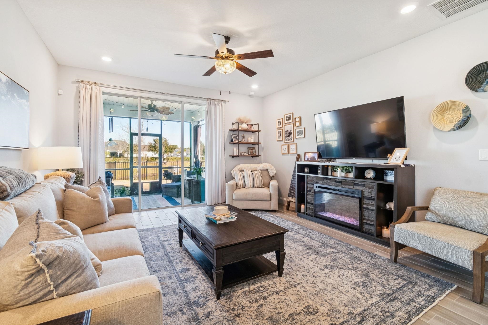262 Killarney Avenue St. Johns, FL 32259 - Photo 27 of 100 Living area with light wood-type flooring, a stone fireplace, a ceiling fan, and recessed lighting