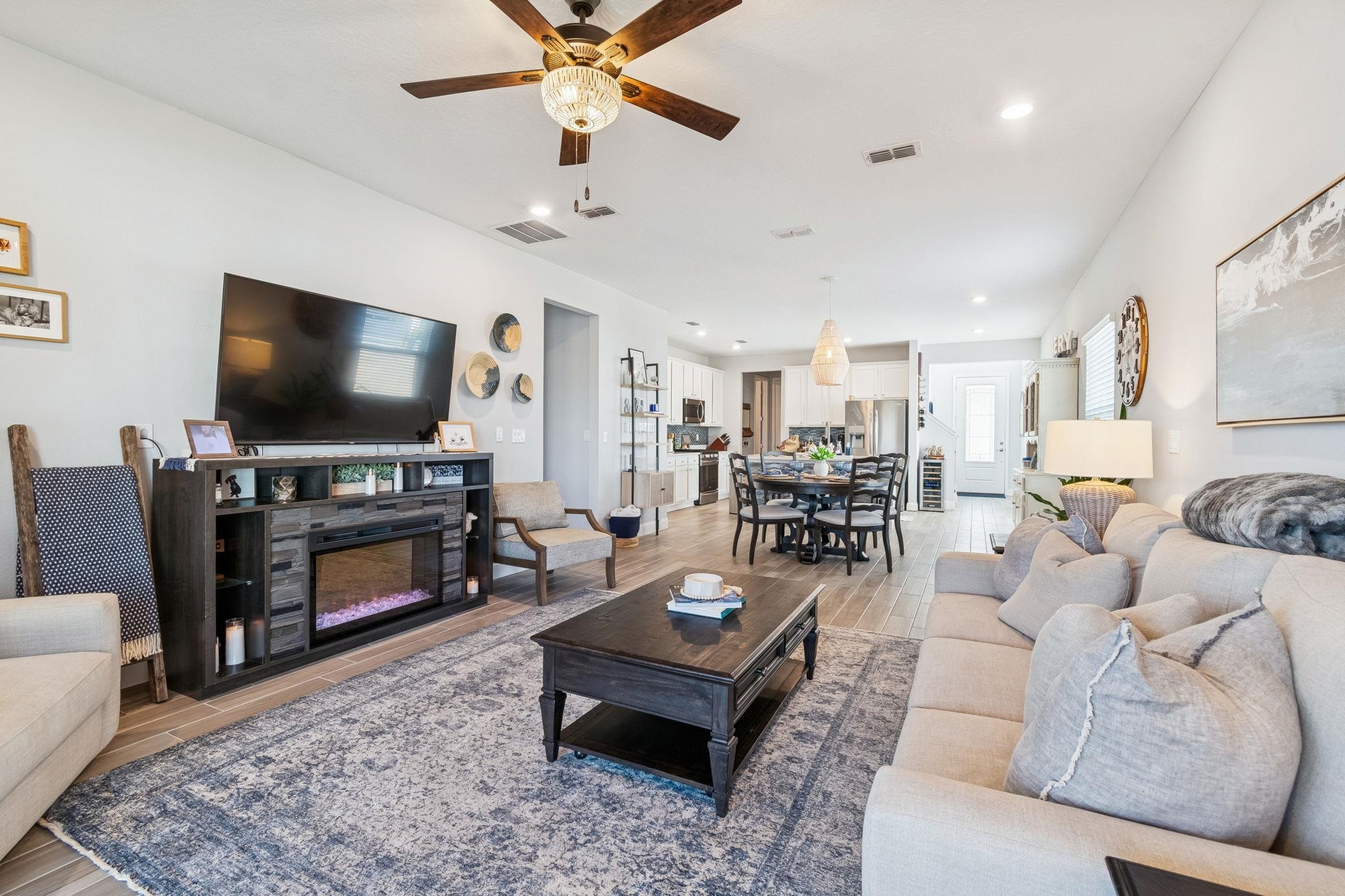 262 Killarney Avenue St. Johns, FL 32259 - Photo 28 of 100 Living room featuring wood tiled floors, a ceiling fan, a glass covered fireplace, and recessed lighting