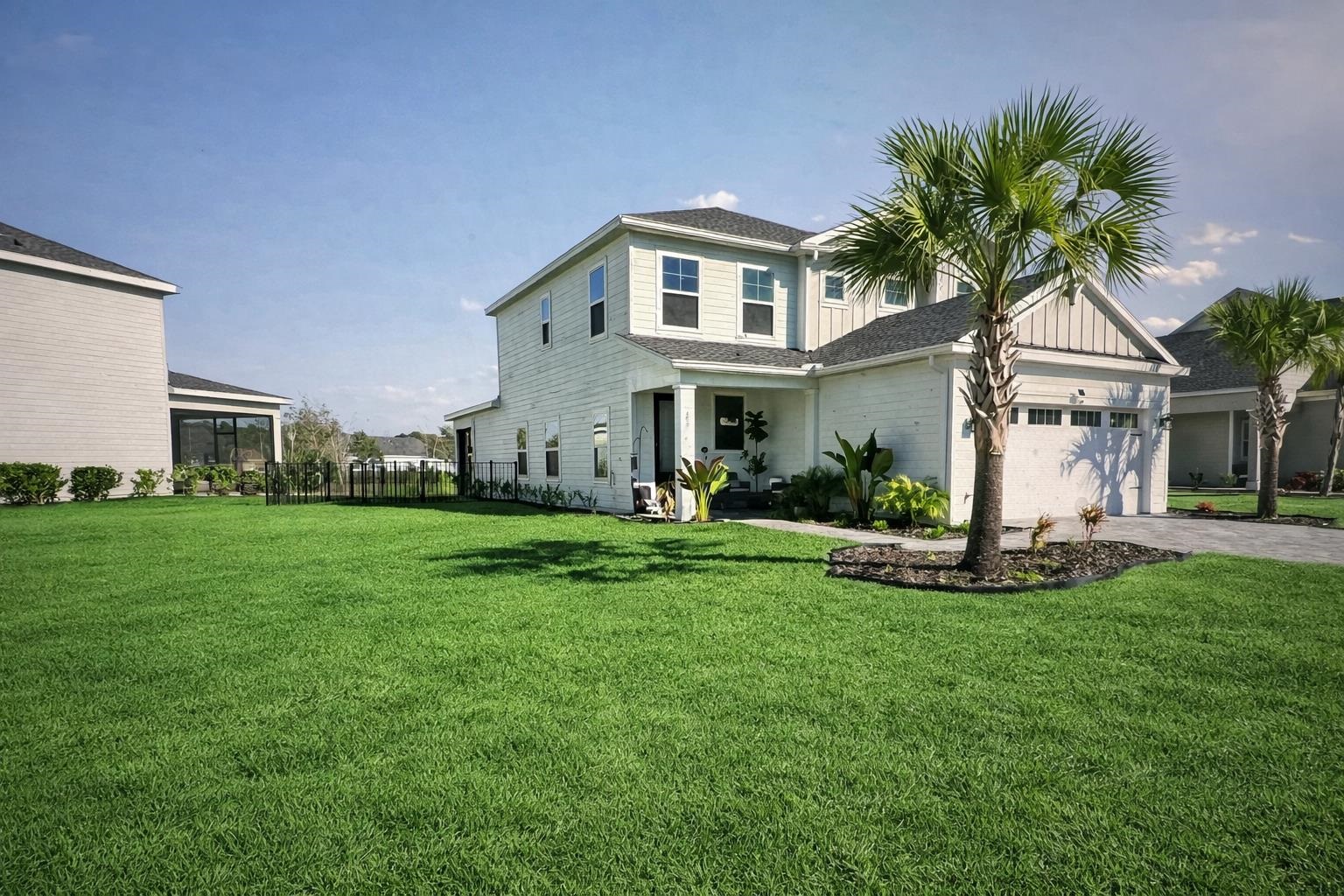 262 Killarney Avenue St. Johns, FL 32259 - Photo 4 of 100 View of front of property featuring board and batten siding, driveway, and a garage