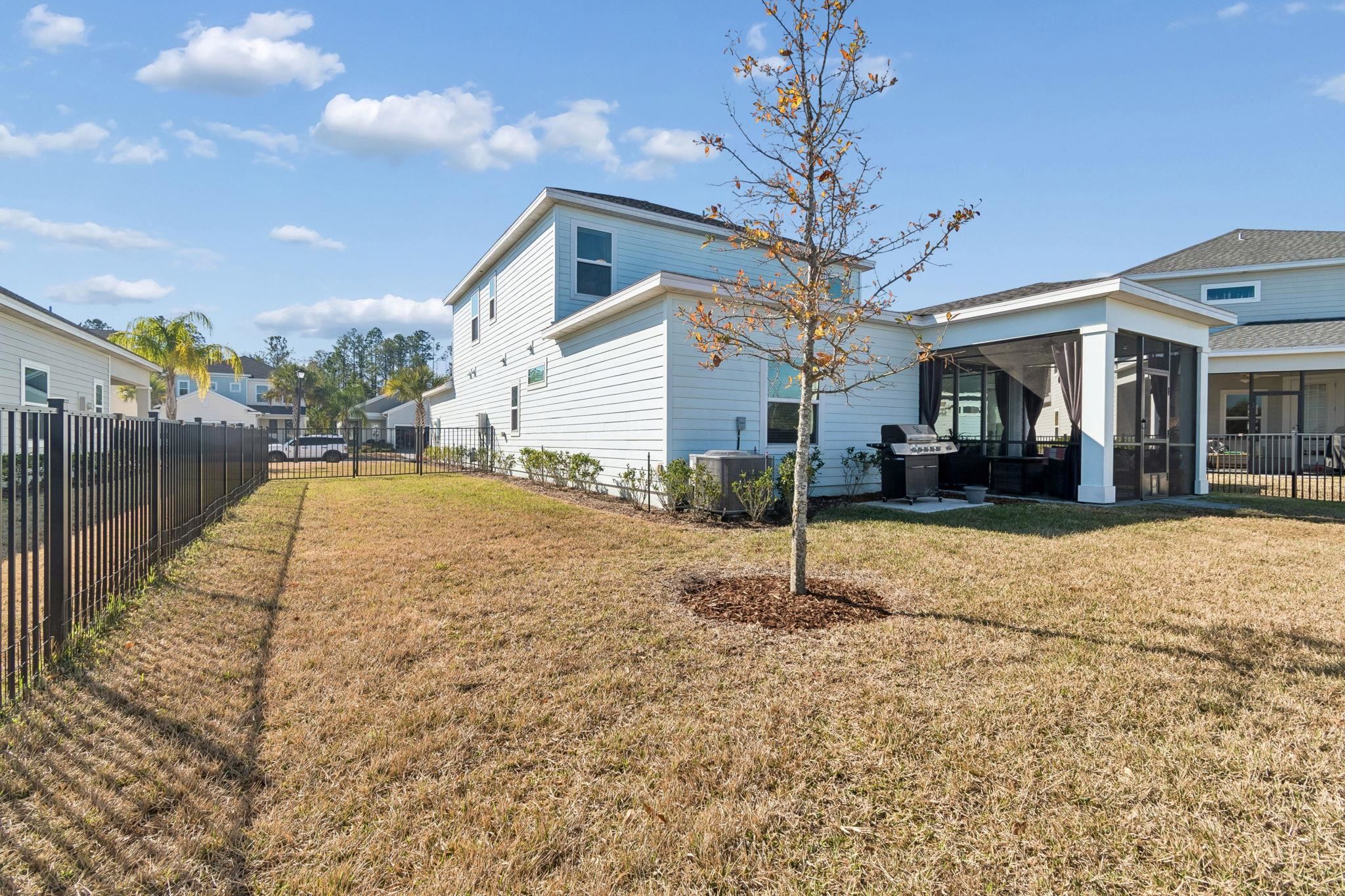 262 Killarney Avenue St. Johns, FL 32259 - Photo 68 of 100 Back of house with a fenced backyard, a patio area, and a sunroom