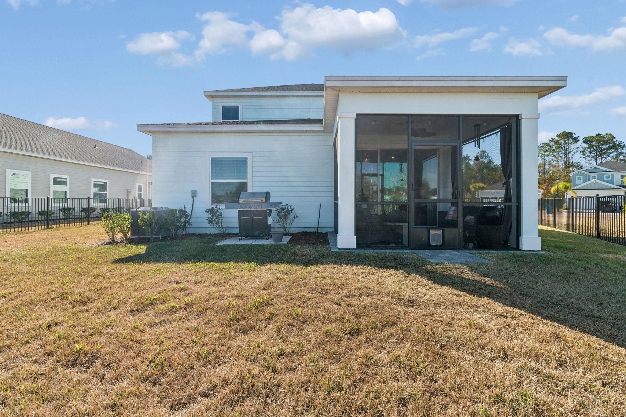 262 Killarney Avenue St. Johns, FL 32259 - Photo 69 of 100 Back of property featuring a fenced backyard, a sunroom, and a patio area