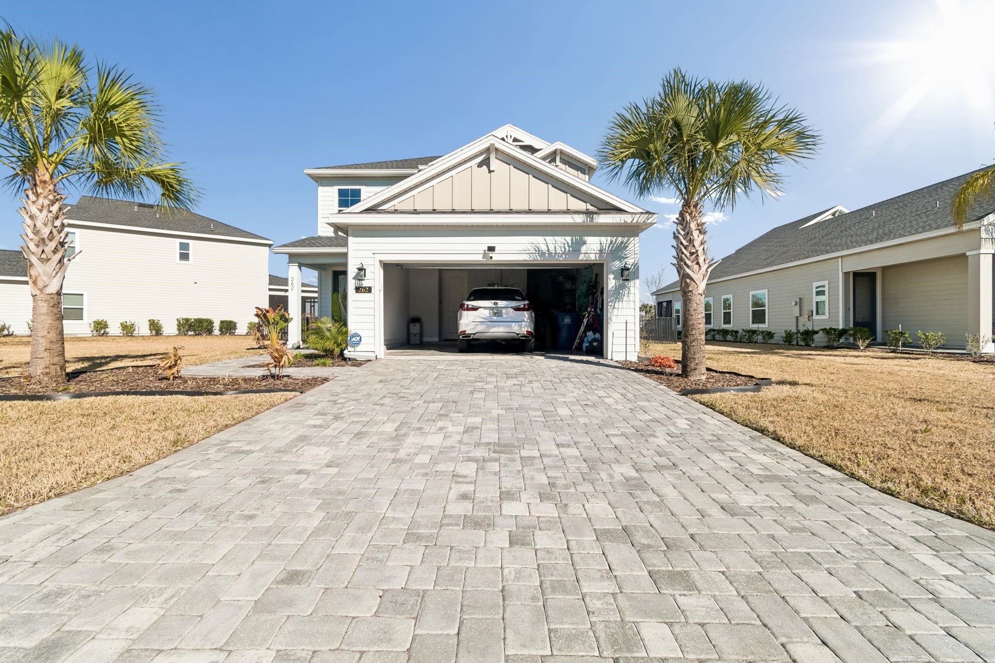 262 Killarney Avenue St. Johns, FL 32259 - Photo 70 of 100 View of front of property with board and batten siding, decorative driveway, and a garage