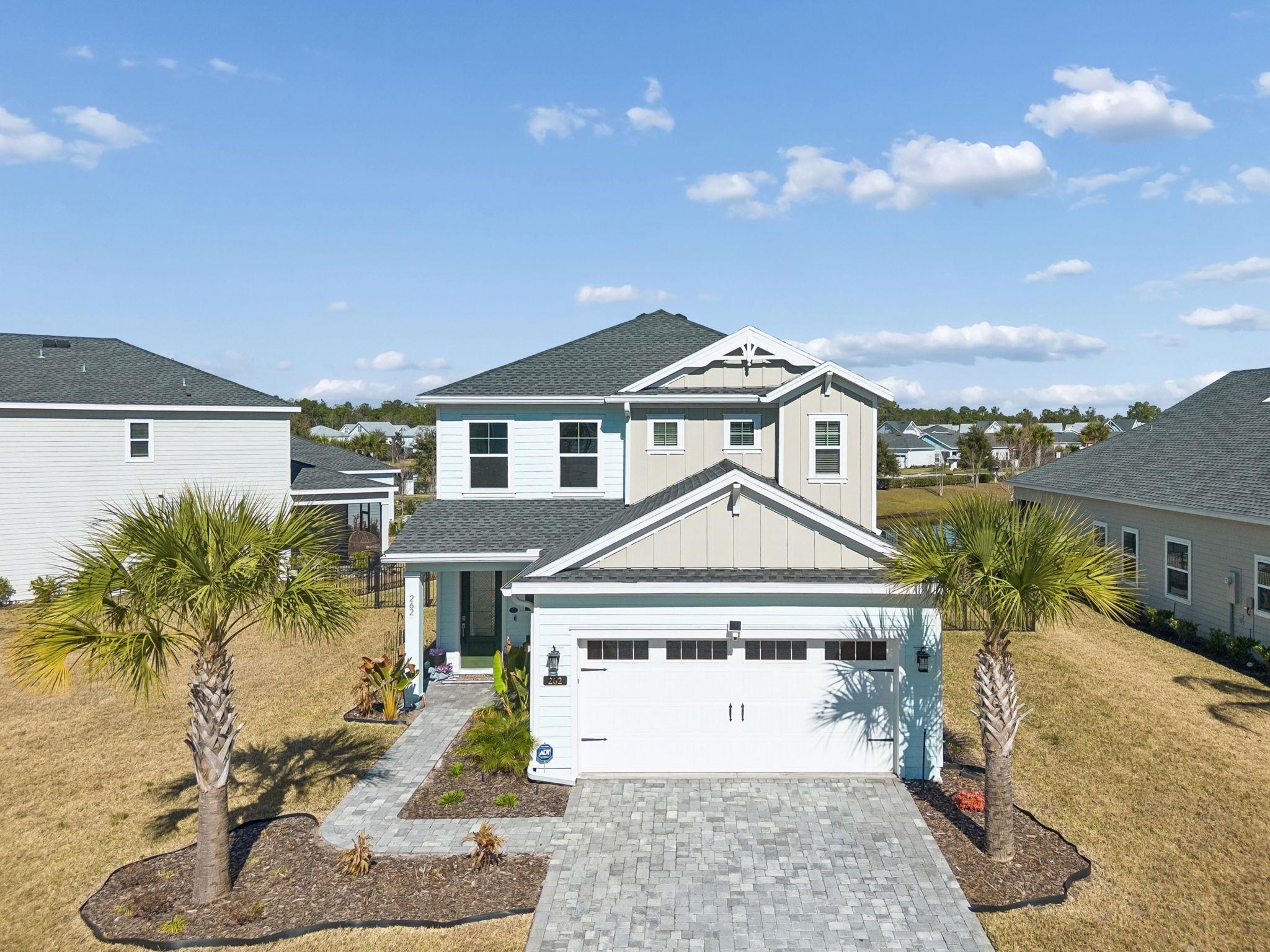 262 Killarney Avenue St. Johns, FL 32259 - Photo 75 of 100 View of front of property featuring board and batten siding, driveway, roof with shingles, a front lawn, and a residential view