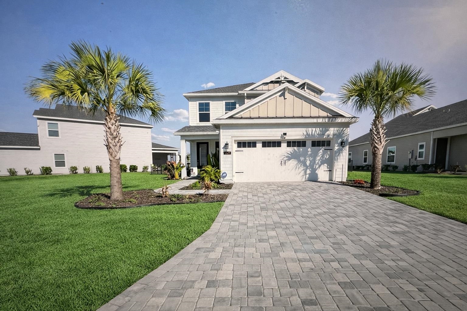 262 Killarney Avenue St. Johns, FL 32259 - Photo 97 of 100 View of front of property with a front lawn, decorative driveway, board and batten siding, and a garage