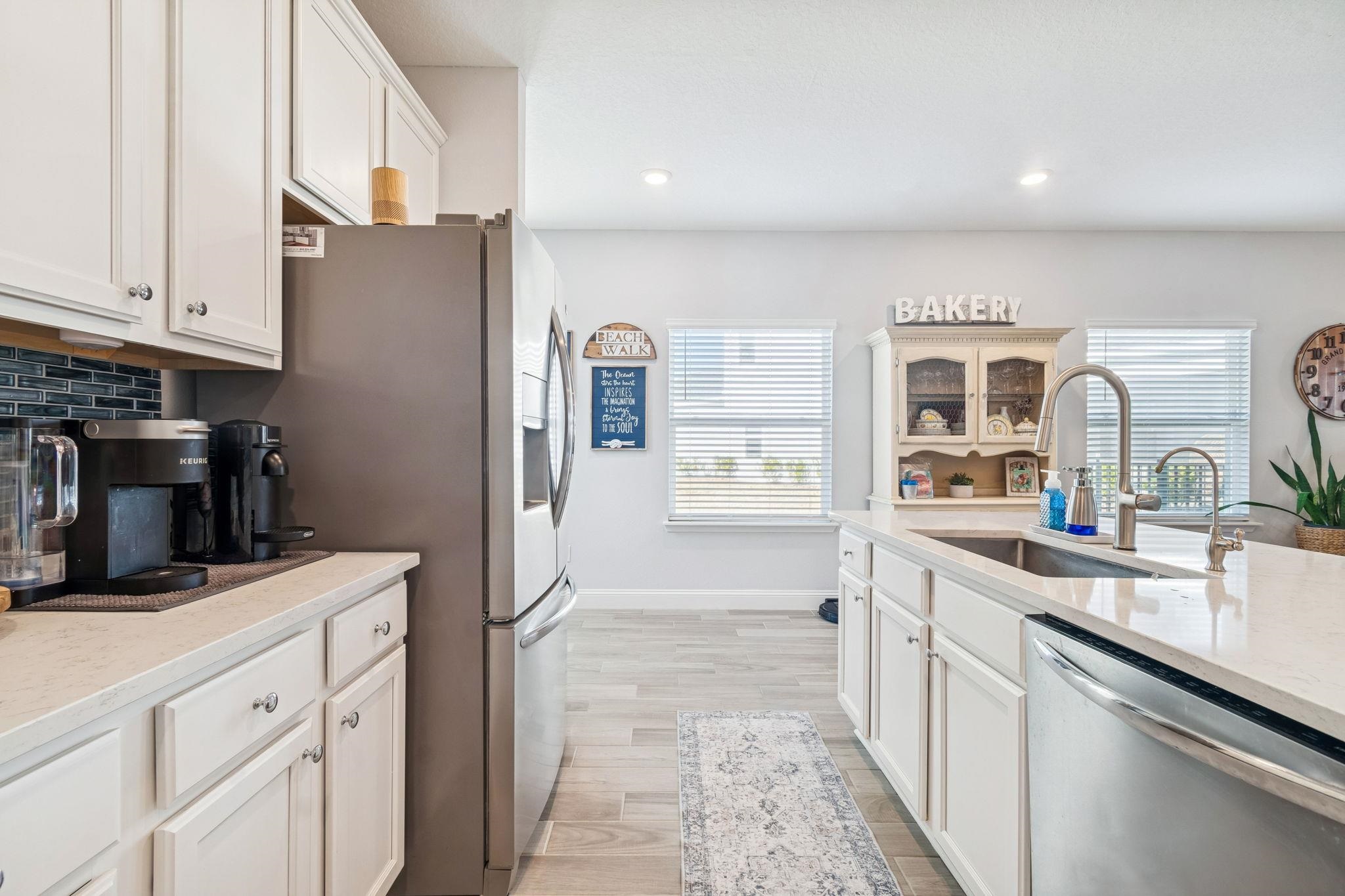 262 Killarney Avenue St. Johns, FL 32259 - Photo 9 of 100 Kitchen with white cabinets, stainless steel appliances, light stone counters, light wood-style floors, and recessed lighting