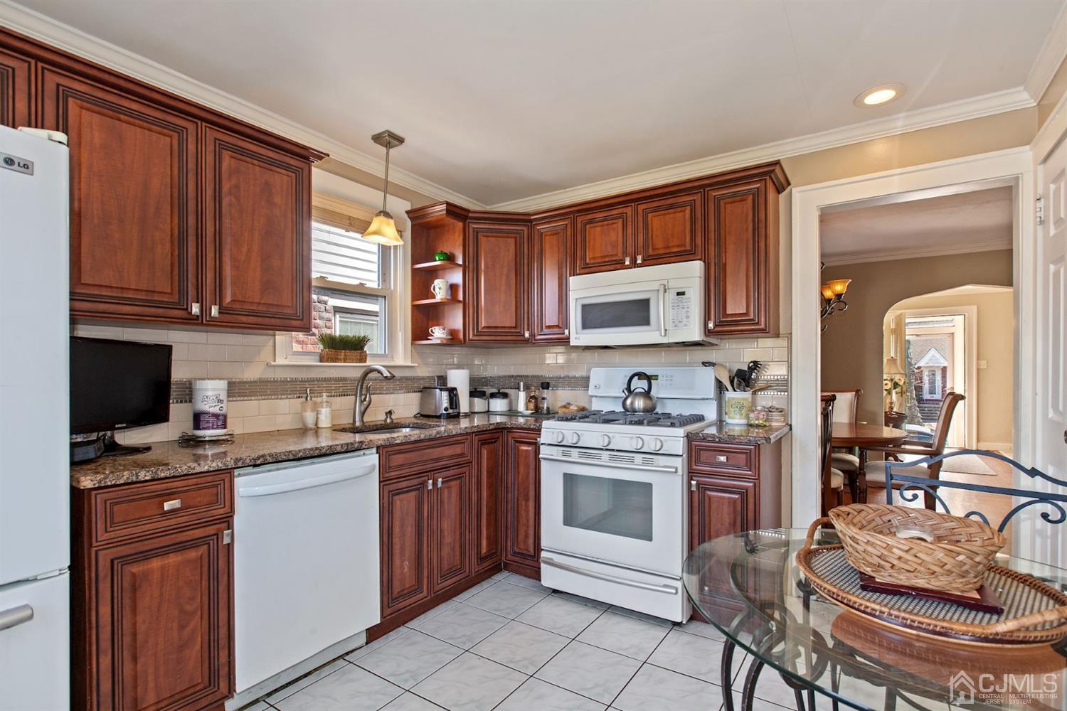 310 Salem Road Union, NJ 07083 - Photo 14 of 27 a kitchen with stainless steel appliances granite countertop a stove top oven a sink dishwasher and cabinets