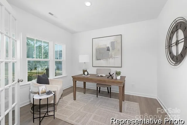a living room with furniture a window and a table