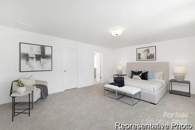 a living room with furniture and a wall painting