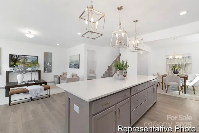a living room with furniture a chandelier and a flat screen tv