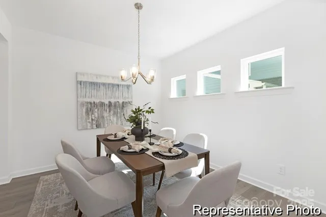 a view of a dining room with furniture and chandelier