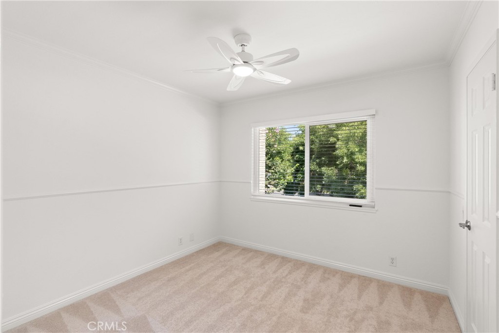 20 Havenwood Irvine, CA 92614 - Photo 16 of 34 Bedroom #2 with a walk in closet, new ceiling fan, fresh paint, and new wood blinds.