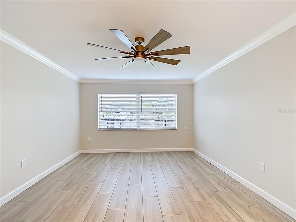 4536 Mitcher Road New Port Richey, FL 34652 - Photo 10 of 46 wooden floor in an empty room with a window