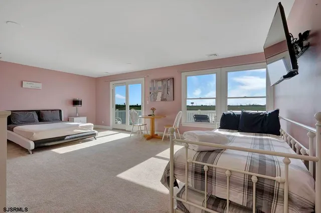 a bedroom with a balcony and a large window