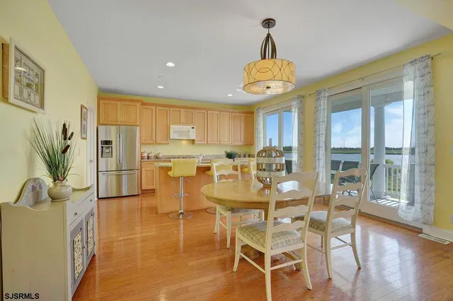 a kitchen with stainless steel appliances granite countertop a refrigerator a stove a sink dishwasher and a refrigerator