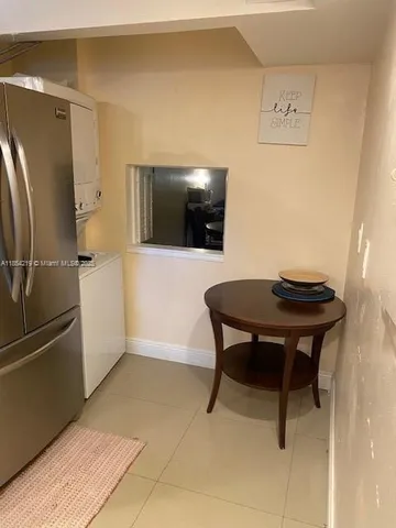 a living room with a table and chairs