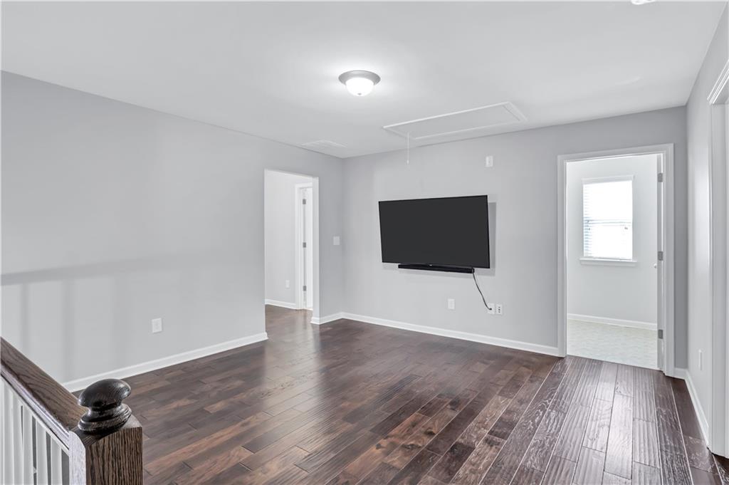 330 Avalon Square Fairburn, GA 30213 - Photo 17 of 52 a view of an empty room with wooden floor and a window