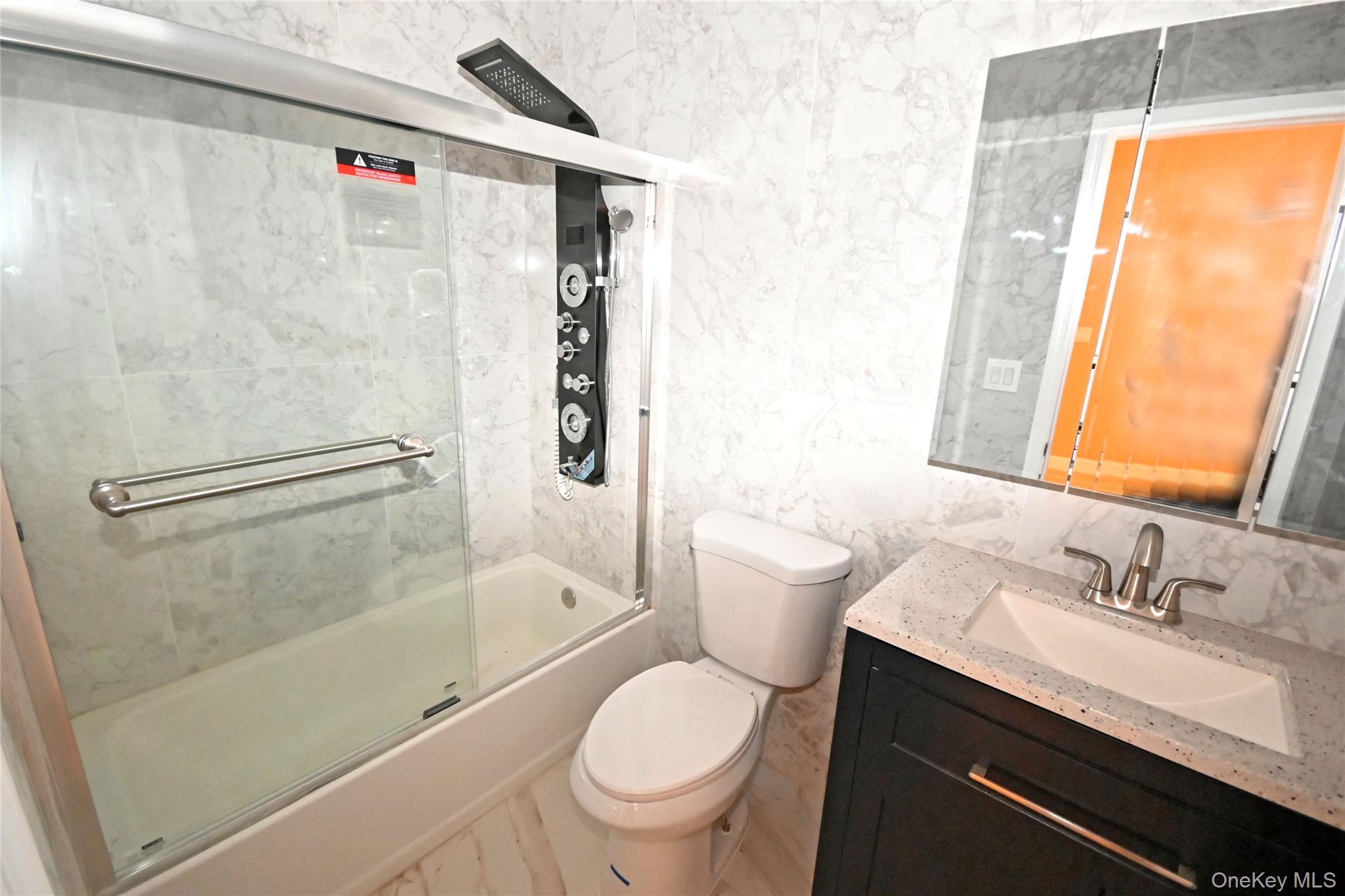 1737 Pacific Street Brooklyn, NY 11213 - Photo 32 of 38 a bathroom with a granite countertop sink toilet and shower