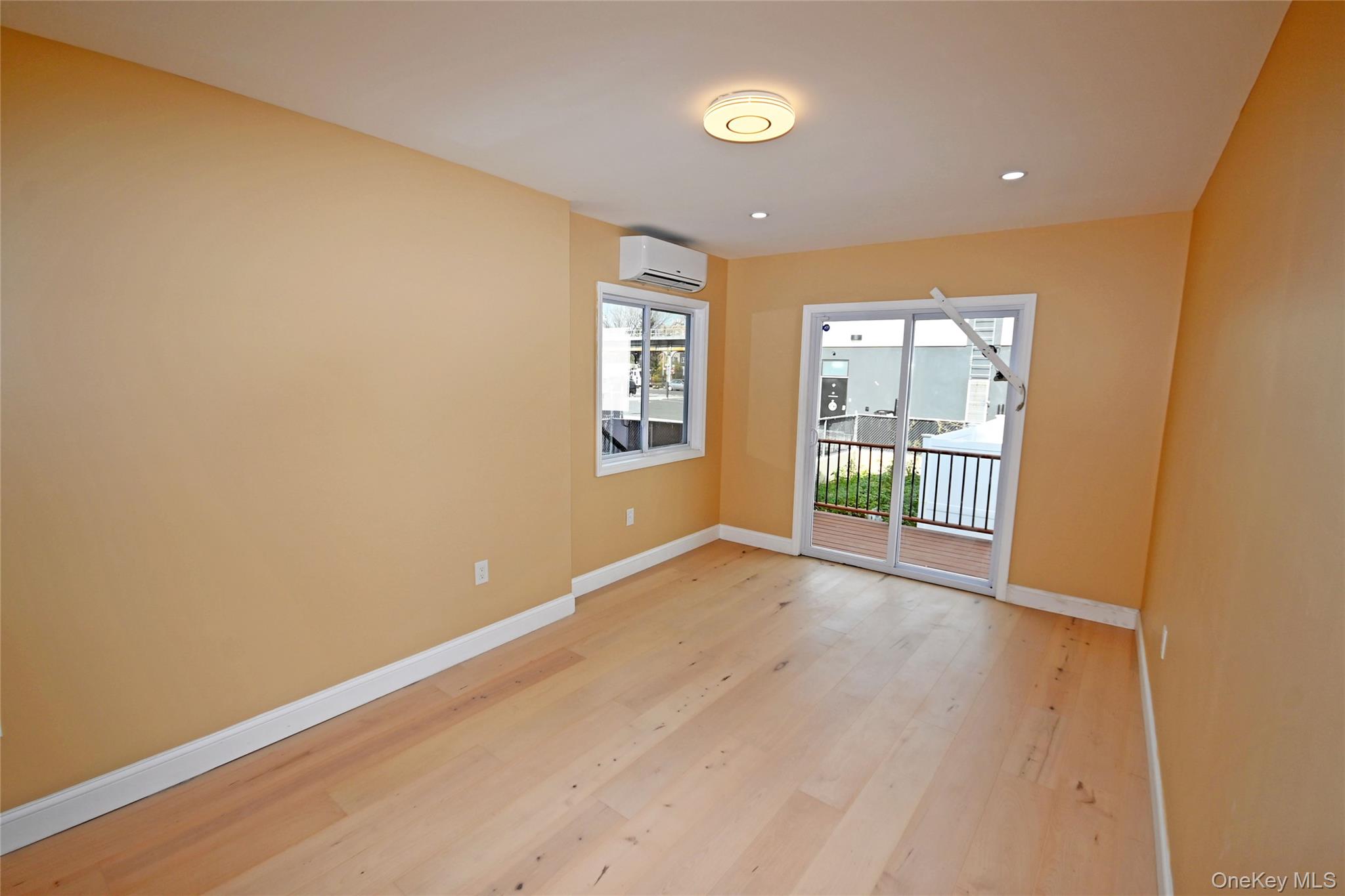 1737 Pacific Street Brooklyn, NY 11213 - Photo 9 of 38 an empty room with wooden floor and windows
