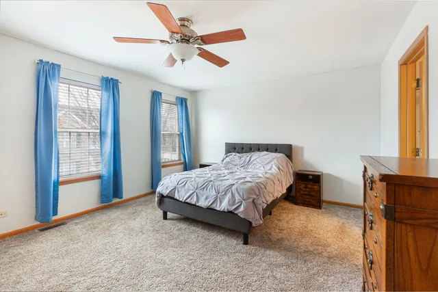 a spacious bedroom with a bed and a large window