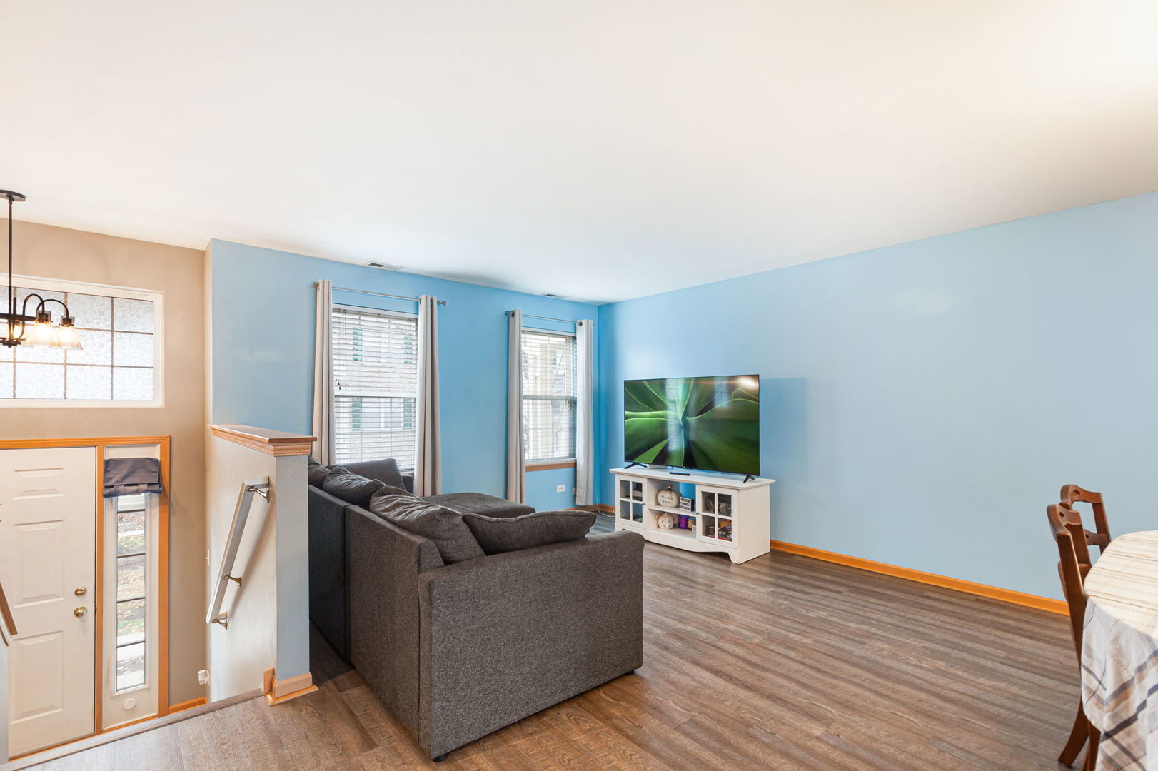 932 Clover Lane Pingree Grove, IL 60140 - Photo 2 of 19 a living room with furniture wooden floor and a flat screen tv